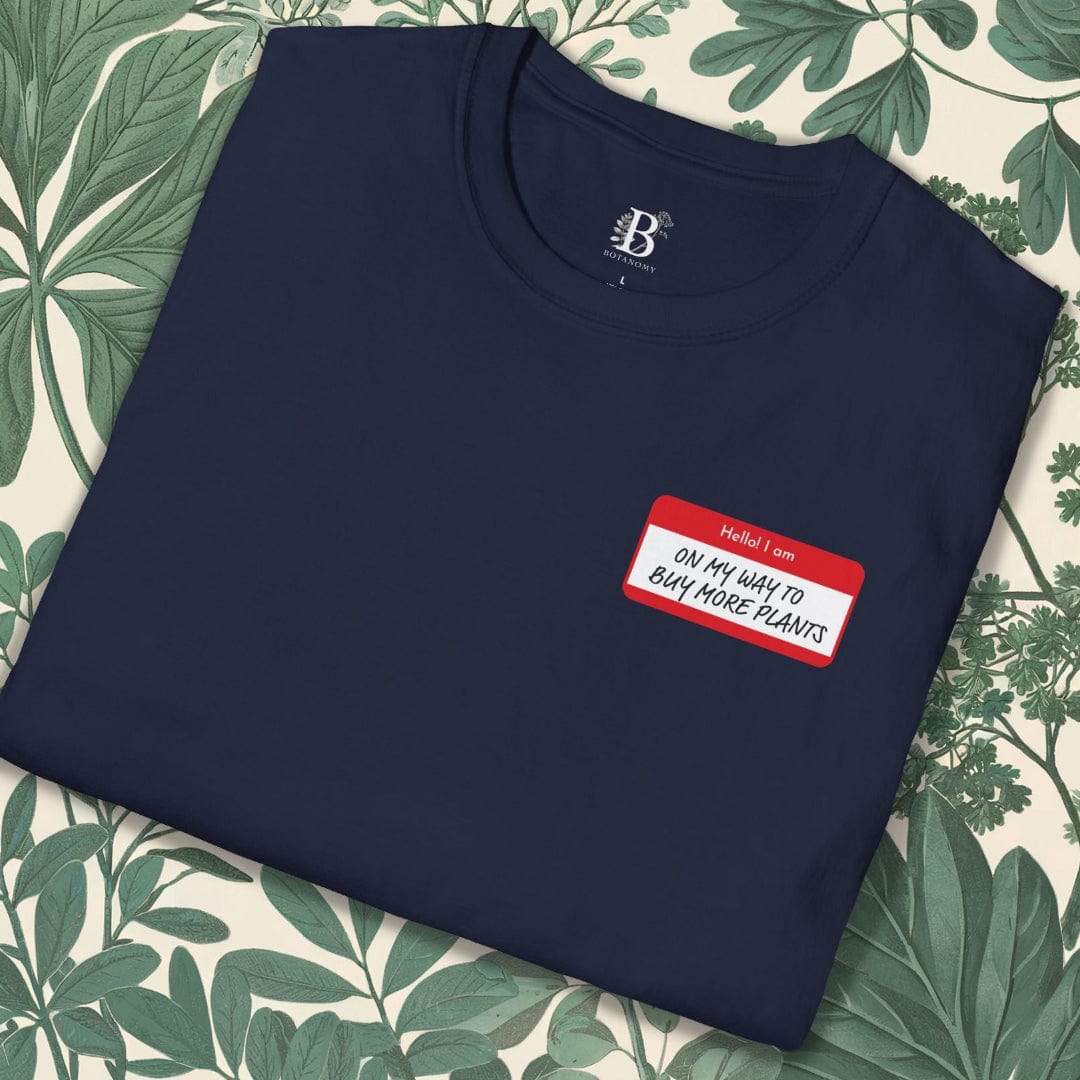 Navy blue sweatshirt with a red name tag label on a floral background