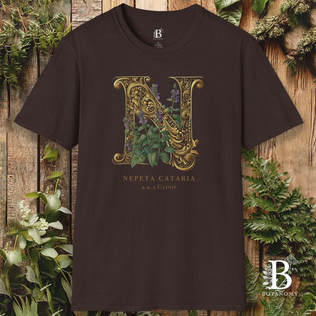 Black t-shirt with gold letter 'N' design on a wooden background with plants