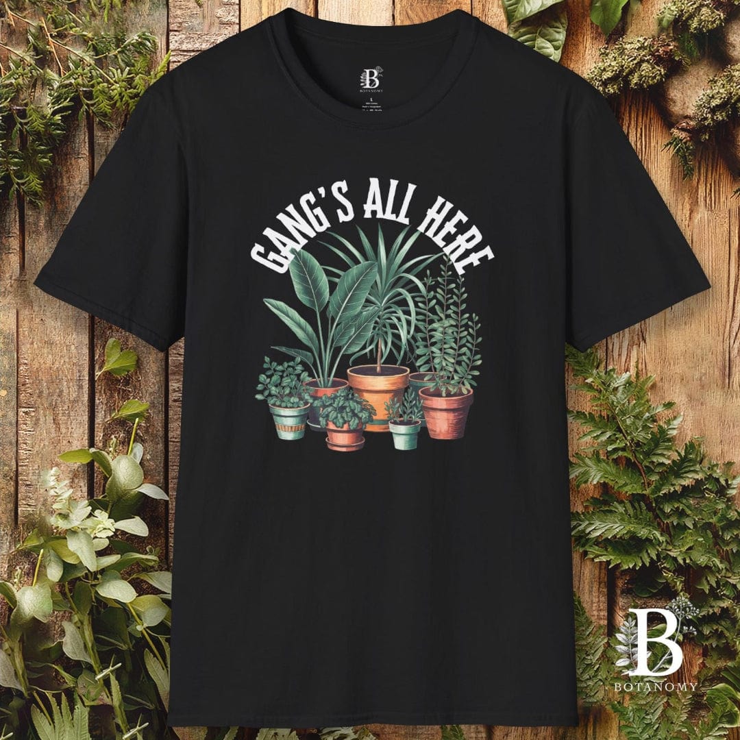 Black t-shirt with plant graphic and 'Gang's All Here' text on a wooden background