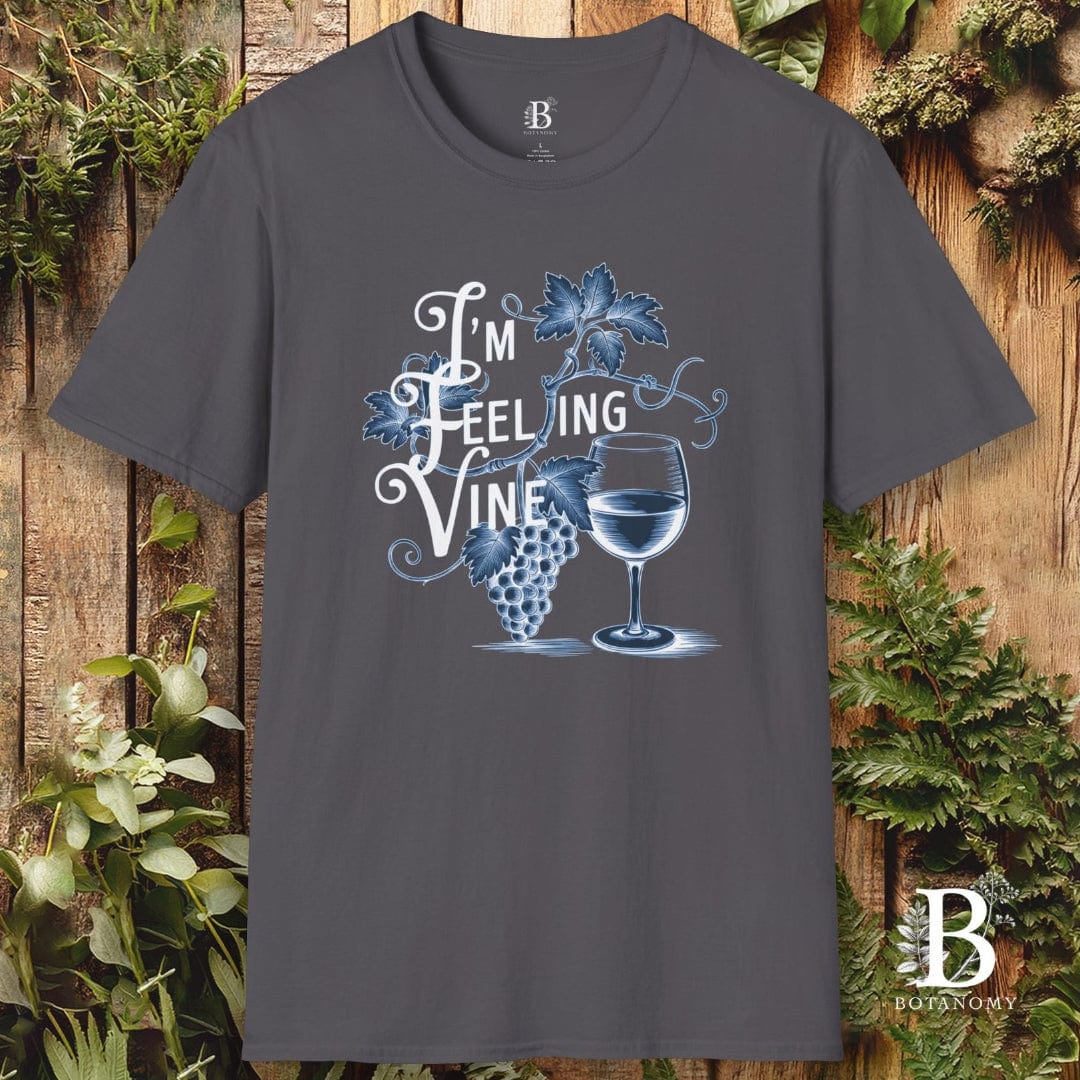 Gray t-shirt with 'I'm Feeling Vine' graphic design on a wooden background with plants.