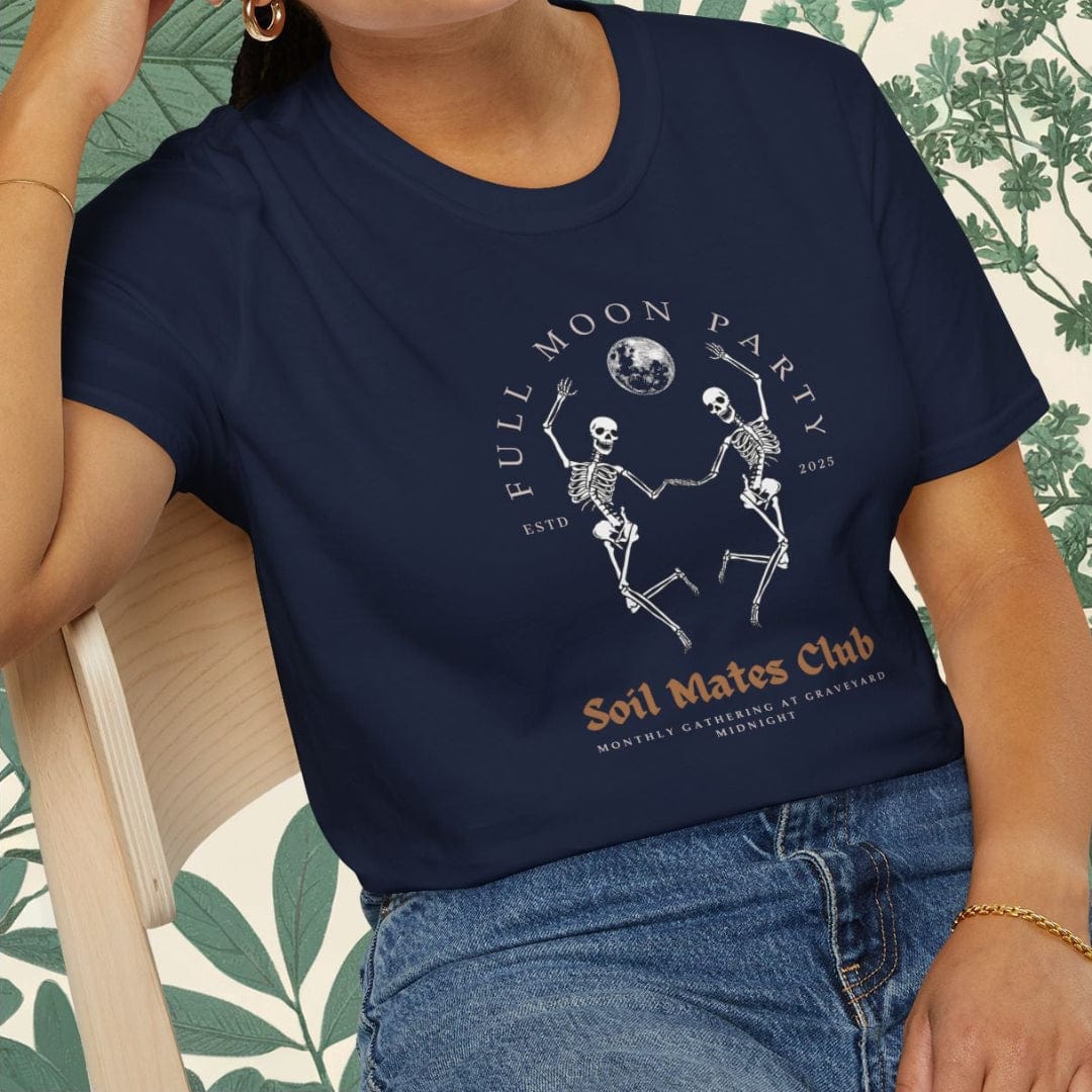 Person wearing a navy blue t-shirt with a graphic design sitting on a chair.