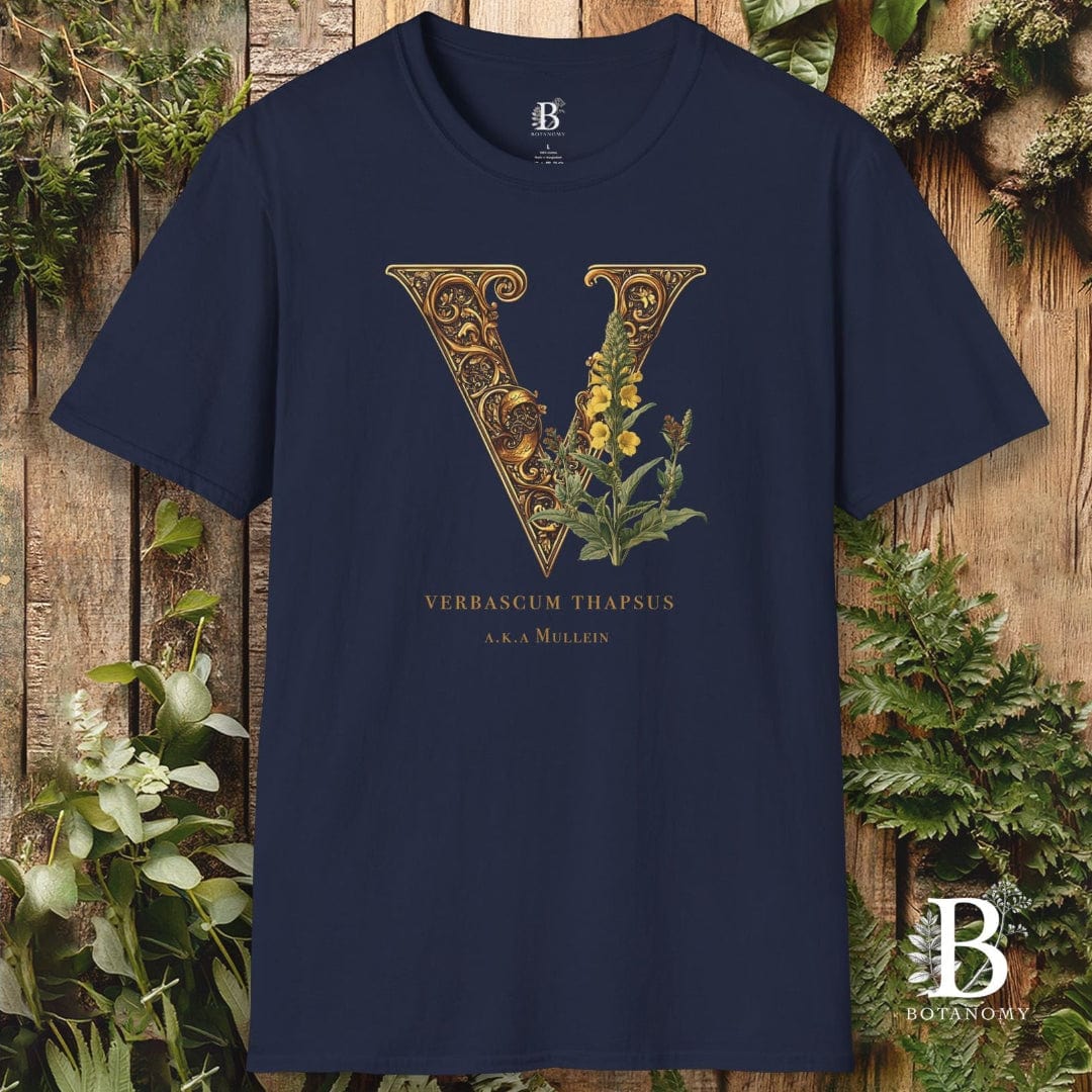 Navy blue t-shirt with decorative letter 'V' and floral design on a wooden background