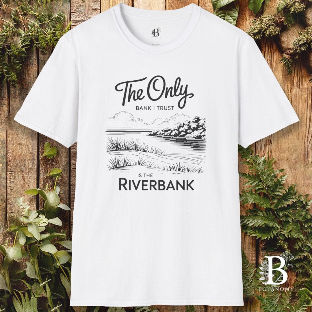 White t-shirt with nature-themed design and text on a wooden background