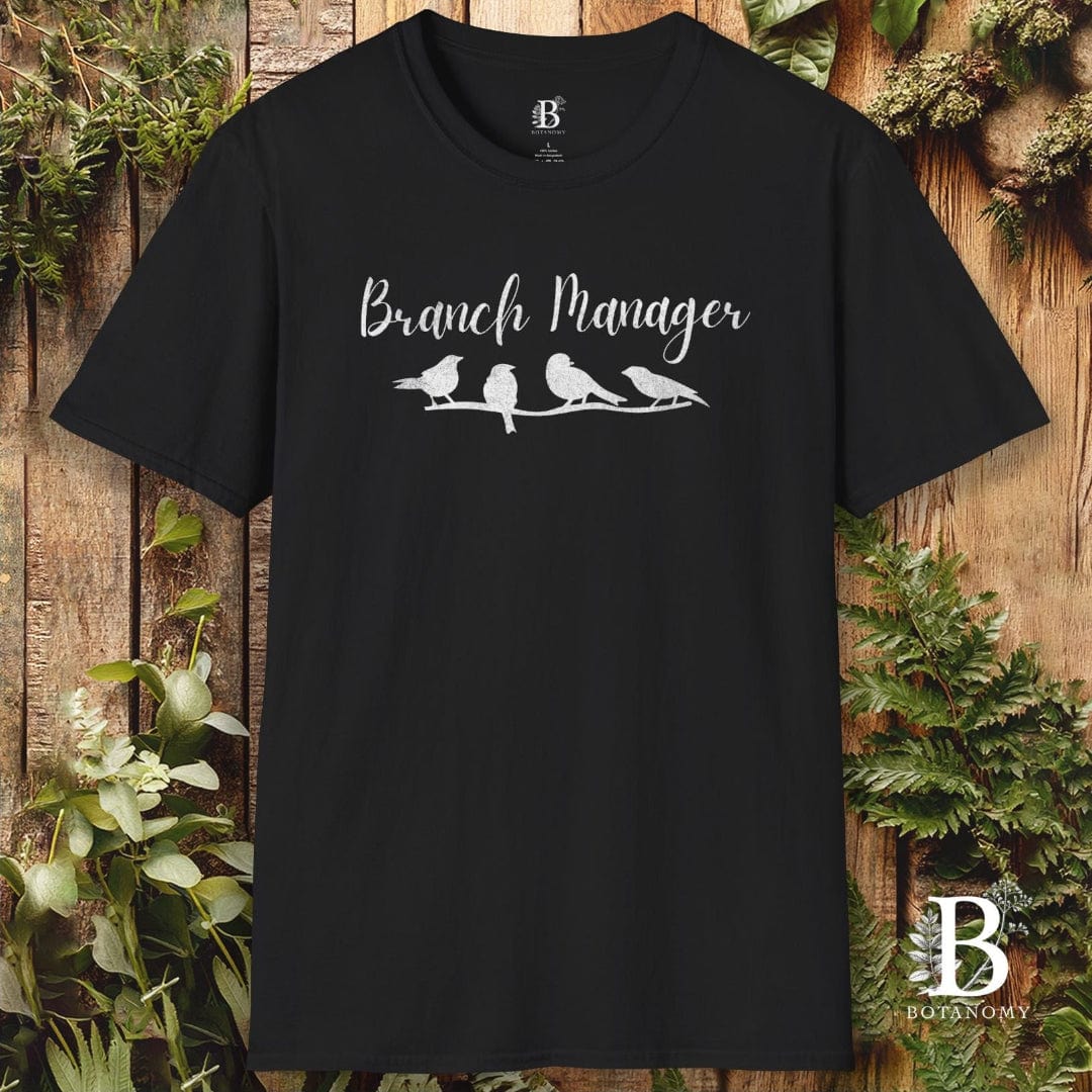Black t-shirt with 'Branch Manager' text and bird design on a wooden background