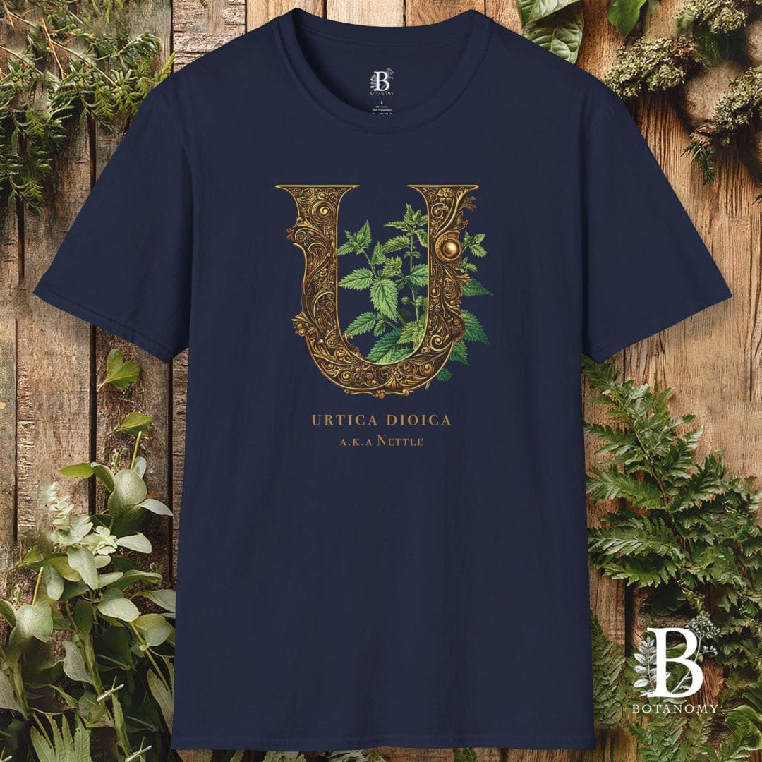 Navy blue t-shirt with decorative letter 'U' design on a wooden background with plants