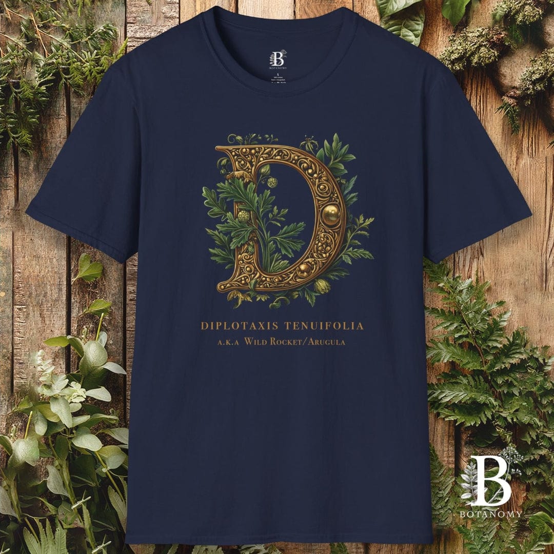 Navy blue t-shirt with decorative letter 'D' design on a wooden background with foliage