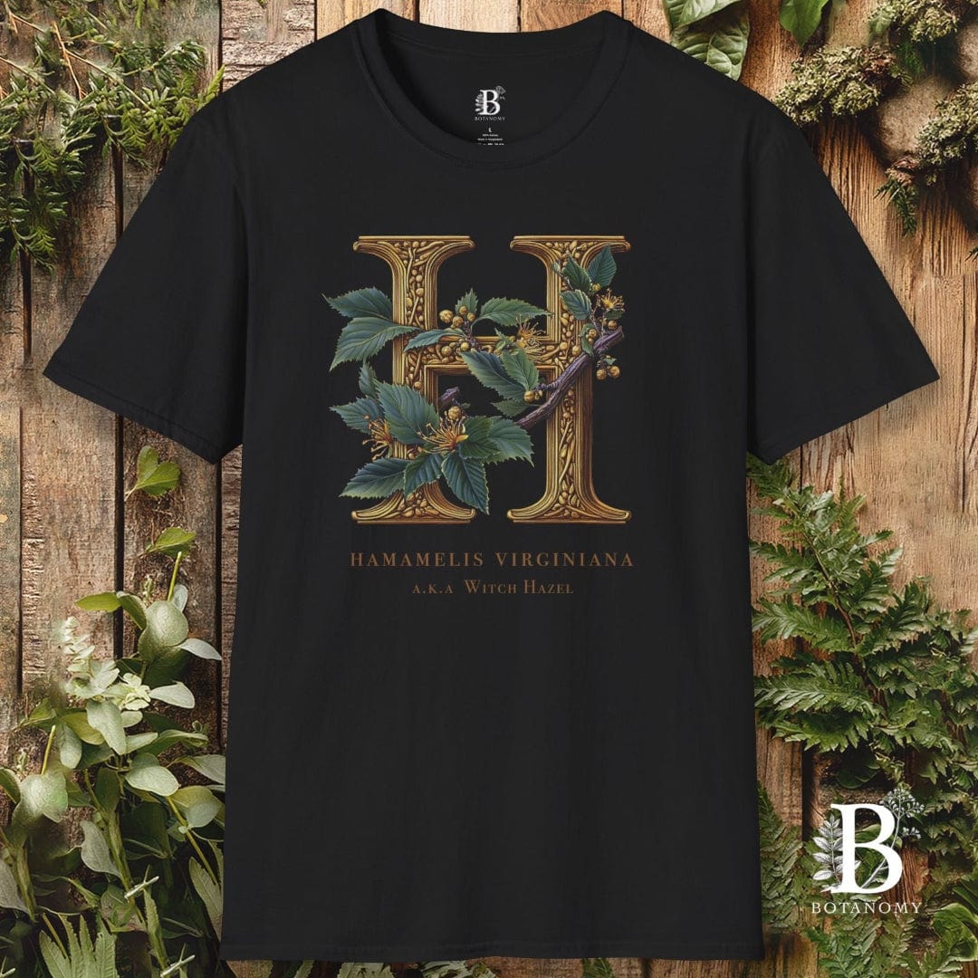 Black t-shirt with floral letter 'H' design on a wooden background