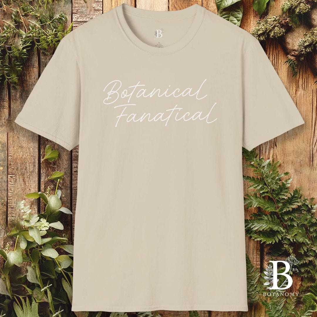 Beige t-shirt with 'Botanical Fanatic' text on a wooden background with plants