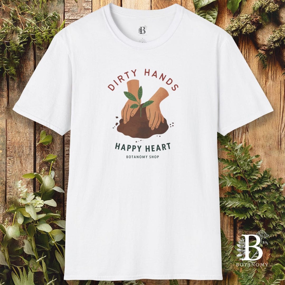 White t-shirt with 'Dirty Hands, Happy Heart' graphic on a wooden background with plants