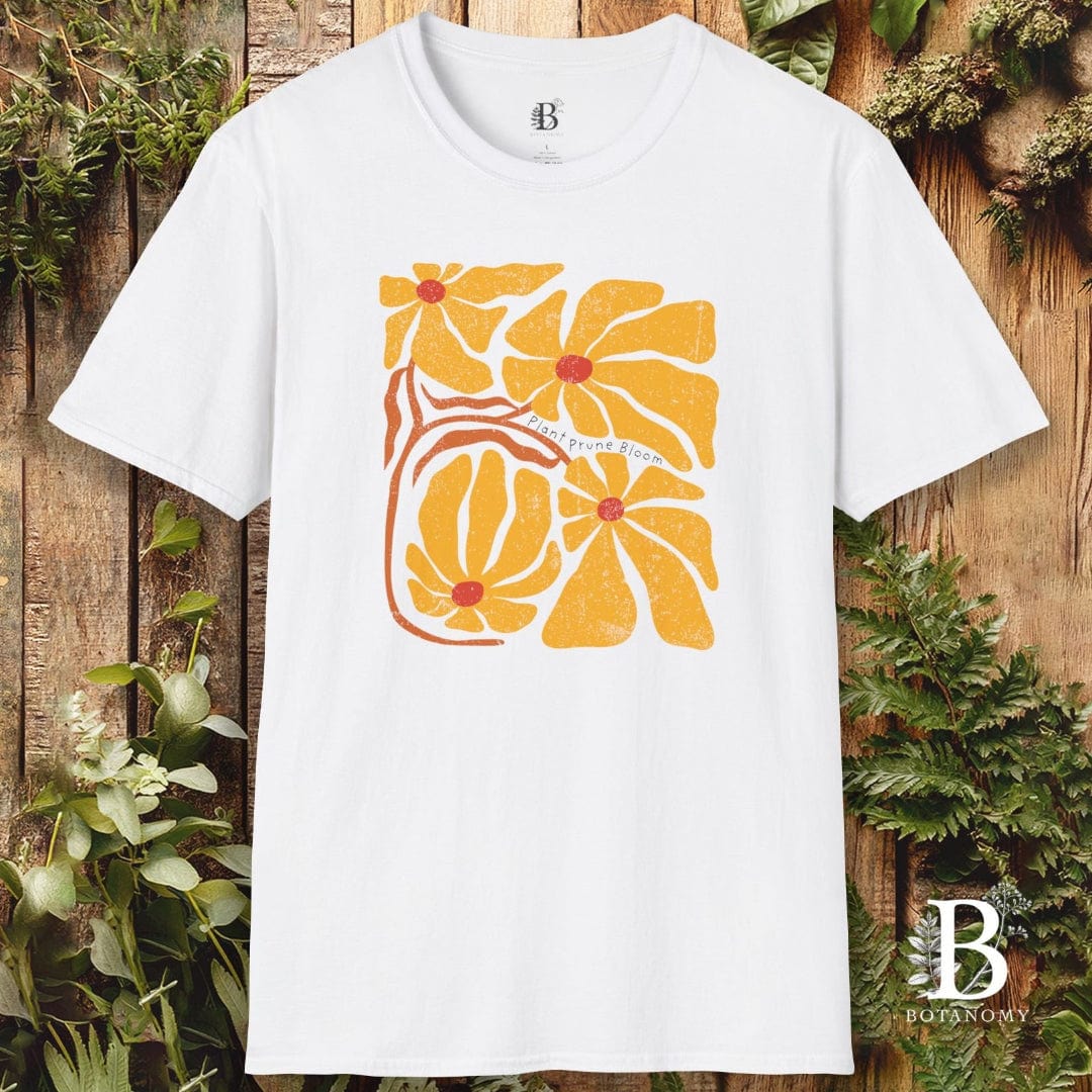 White t-shirt with yellow floral design on a wooden background