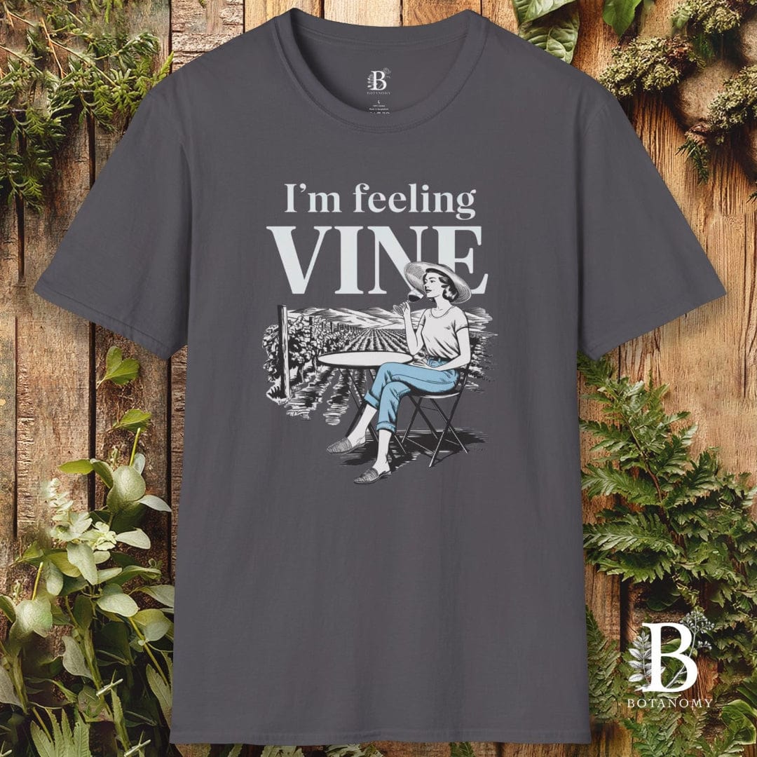 Gray t-shirt with 'I'm feeling vine' graphic design on a wooden background