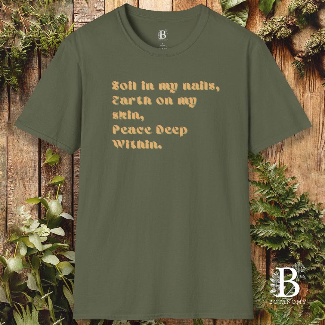 Green t-shirt with text on a wooden background with plants