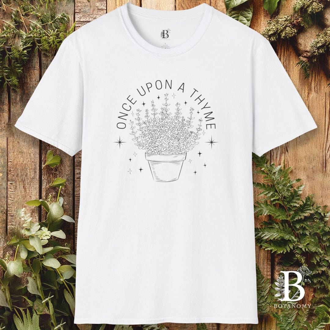 White t-shirt with 'Once Upon a Thyme' design on a wooden background with plants.