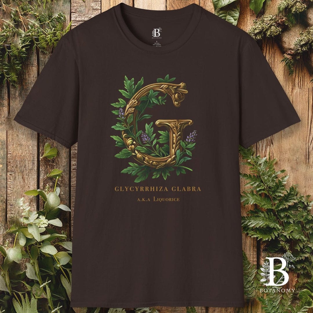 Black t-shirt with gold letter 'G' and green leaves on a wooden background