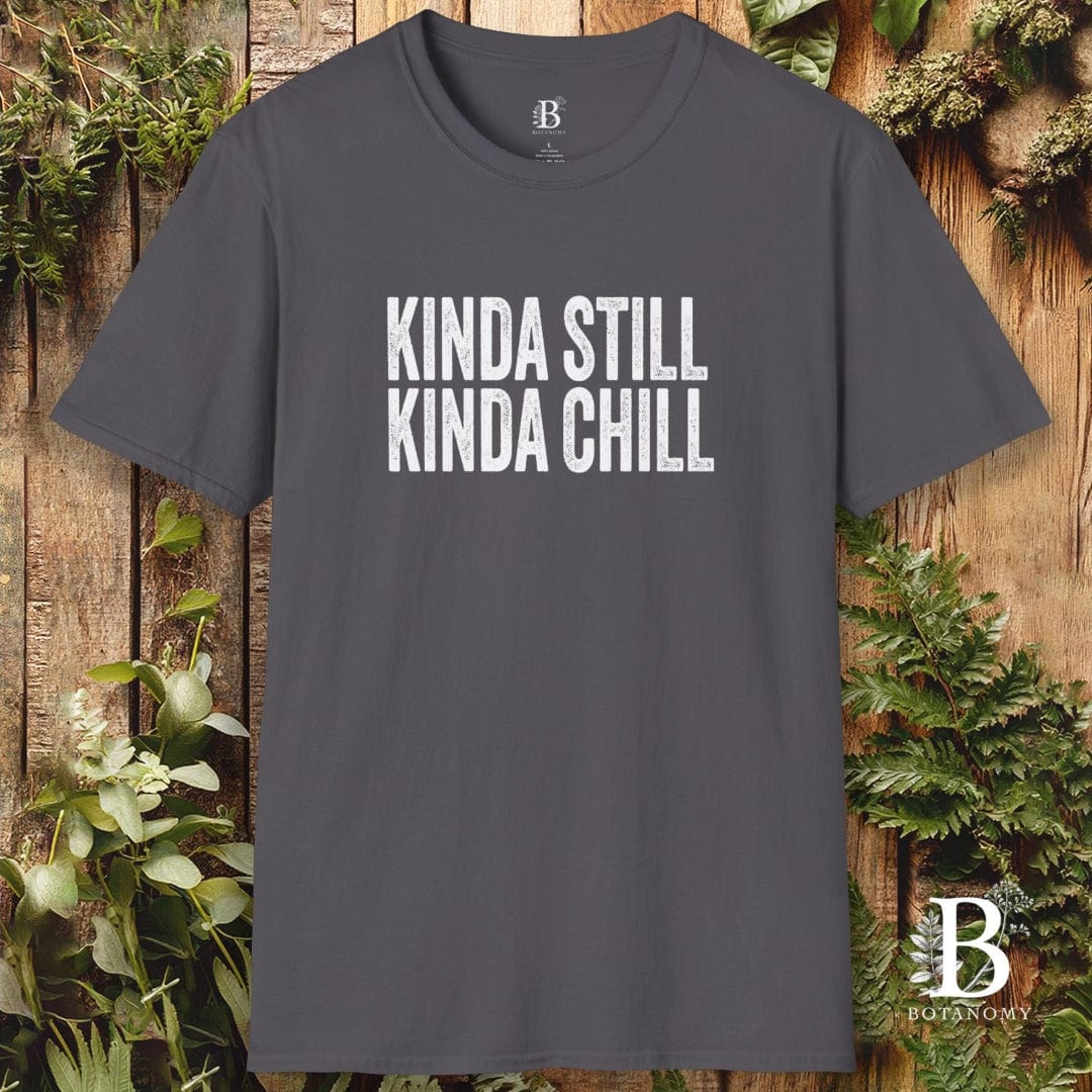 Gray t-shirt with 'KINDA STILL KINDA CHILL' text on a wooden background