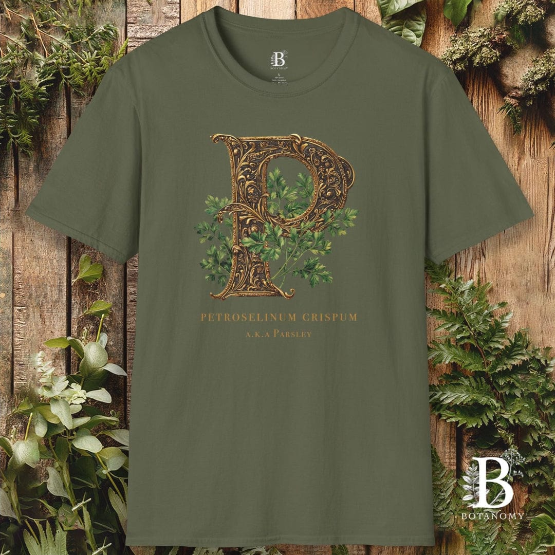 Green t-shirt with decorative letter 'P' design on a wooden background