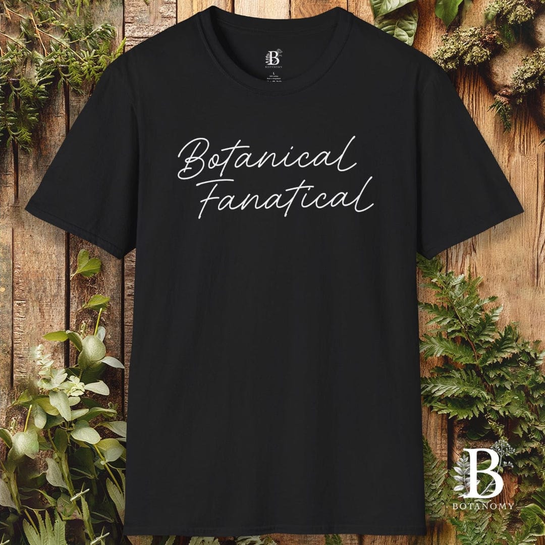 Black t-shirt with 'Botanical Fanatical' text on a wooden background with plants