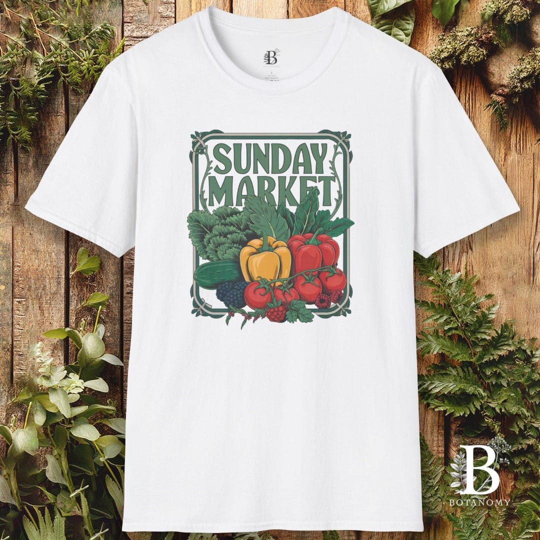 White t-shirt with 'Sunday Market' graphic design featuring vegetables on a wooden background.