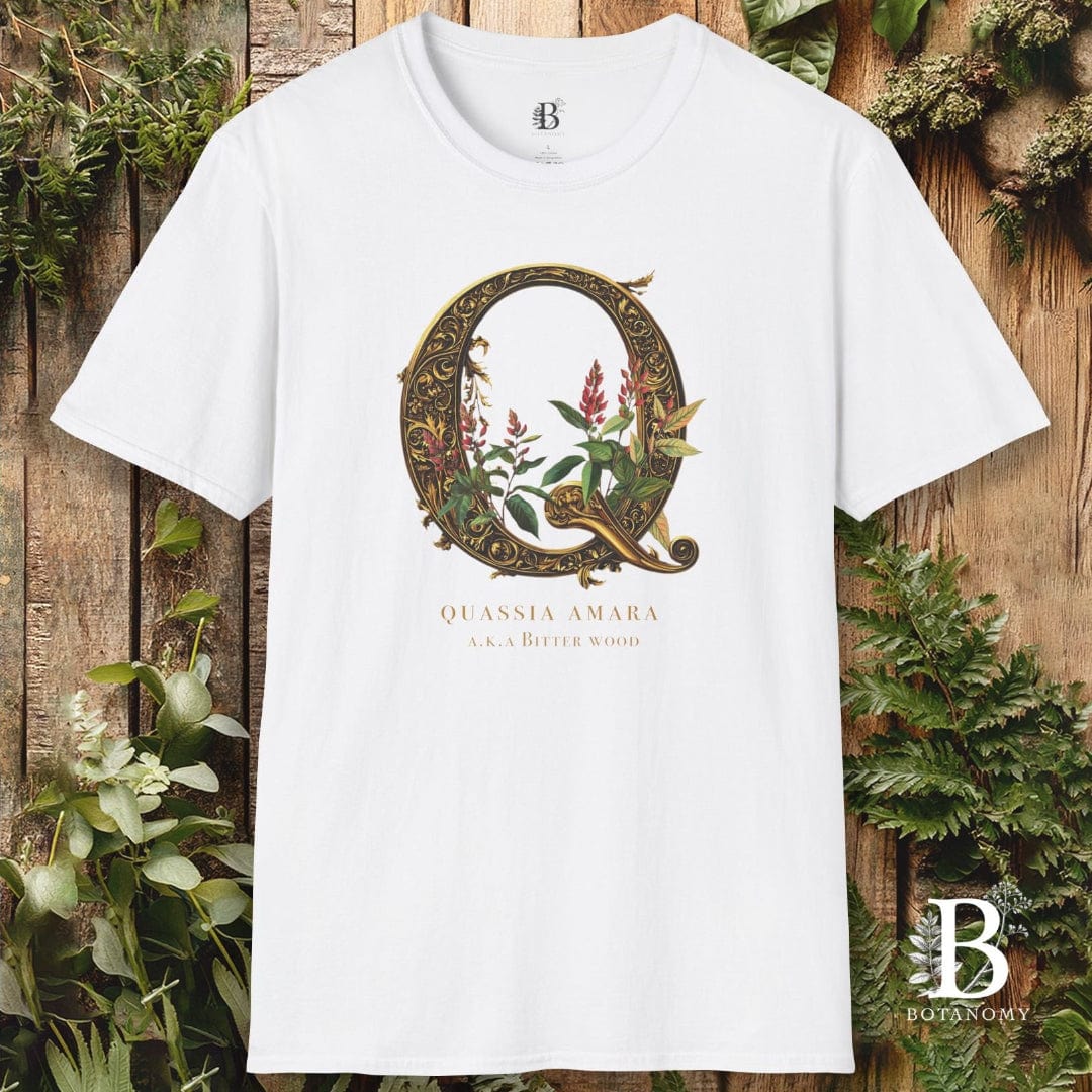 White t-shirt with decorative letter 'Q' design on a wooden background with plants