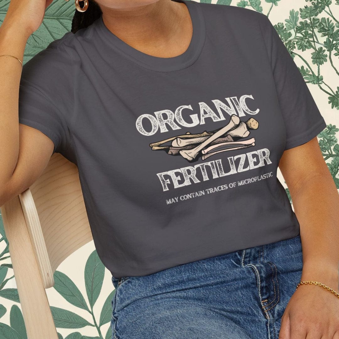 Person wearing a gray t-shirt with 'Organic Fertilizer' text and graphics, sitting on a chair.