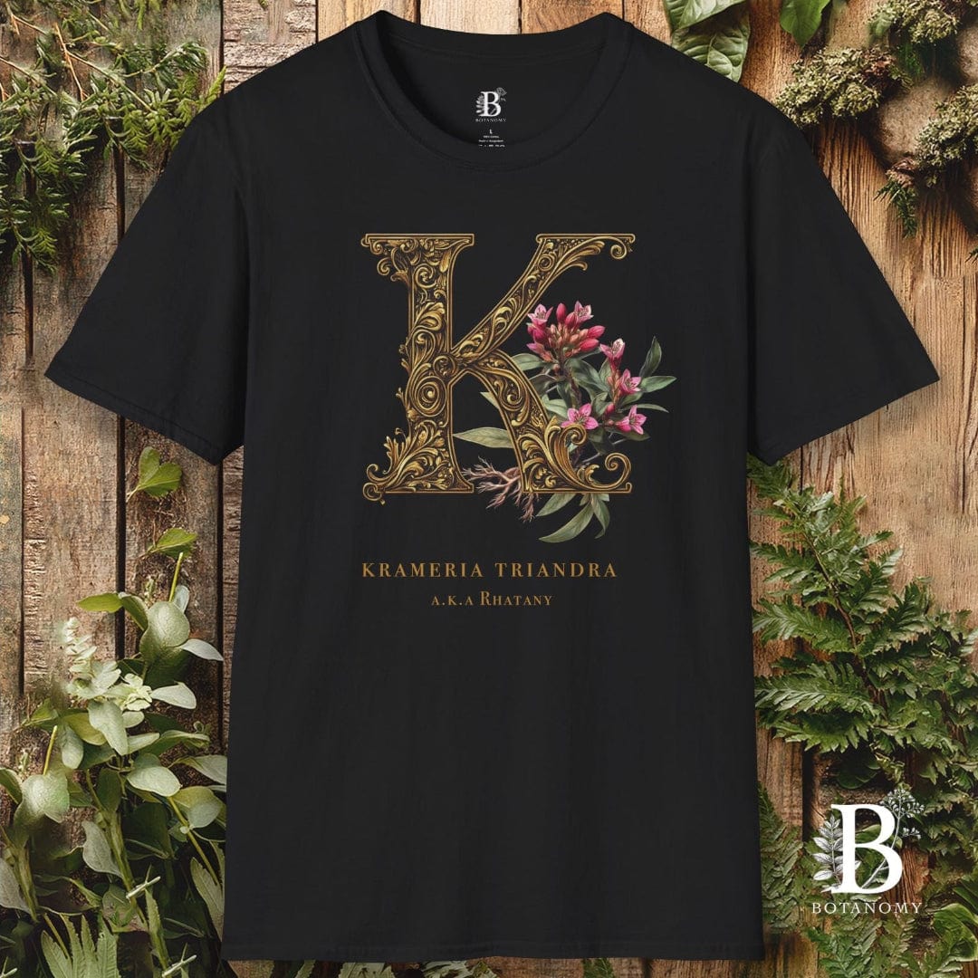 Black t-shirt with decorative 'K' design on a wooden background