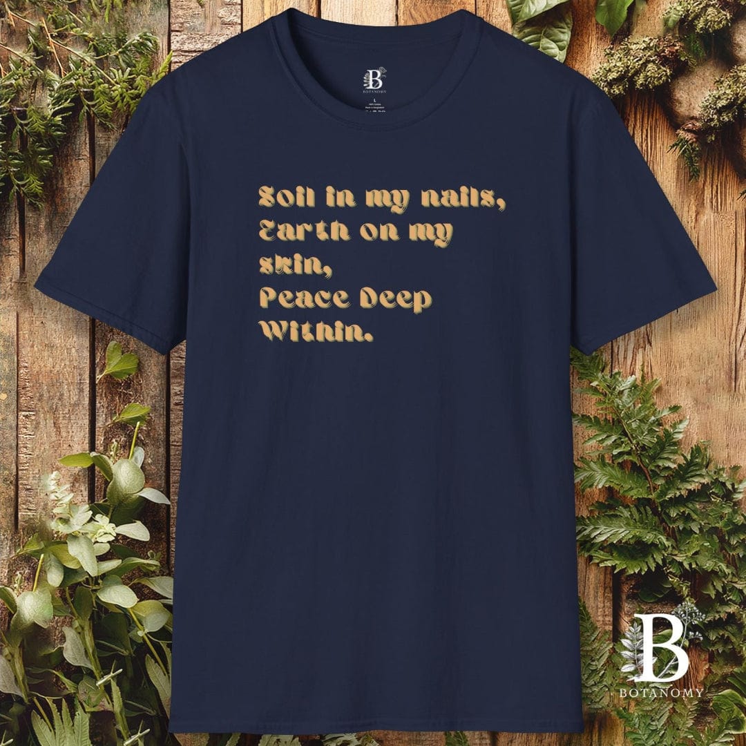 Navy blue t-shirt with gold text on a wooden background