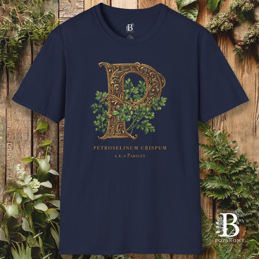 Navy blue t-shirt with decorative letter 'P' design on a wooden background with plants