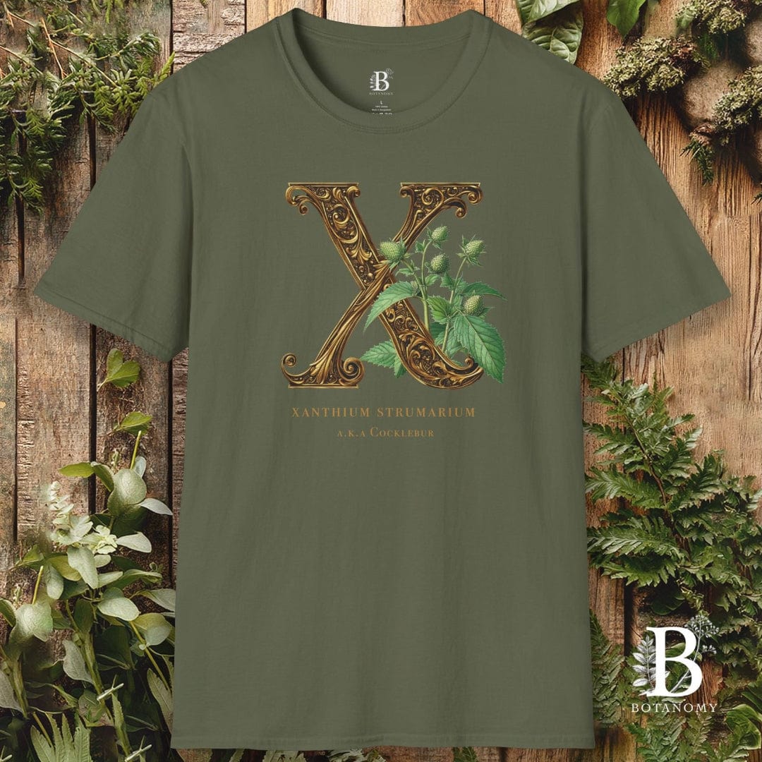 Green t-shirt with decorative letter 'X' design on a wooden background