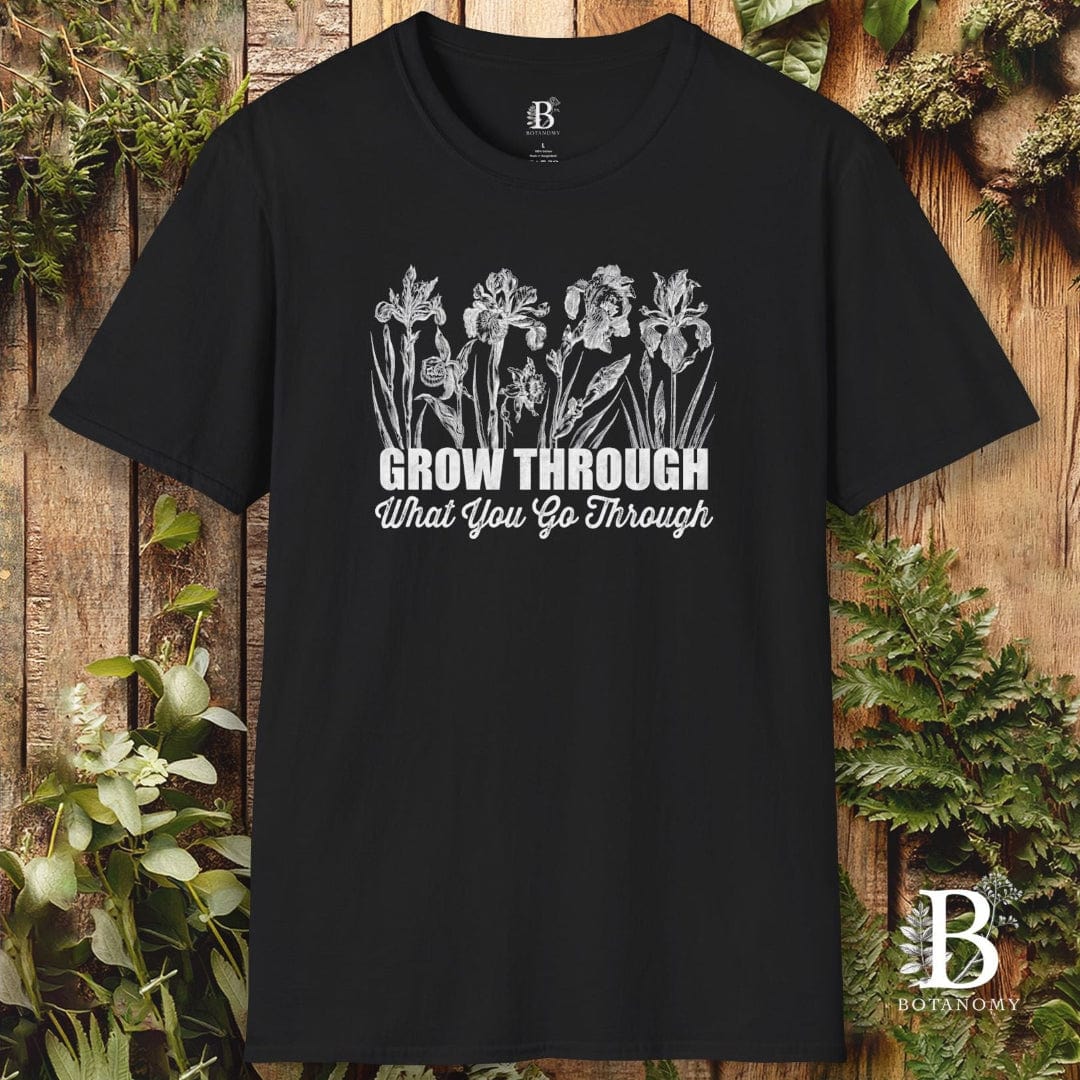 Black t-shirt with floral design and text on a wooden background