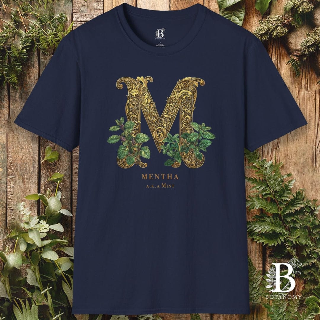 Navy blue t-shirt with decorative 'M' design and brand logo on a wooden background