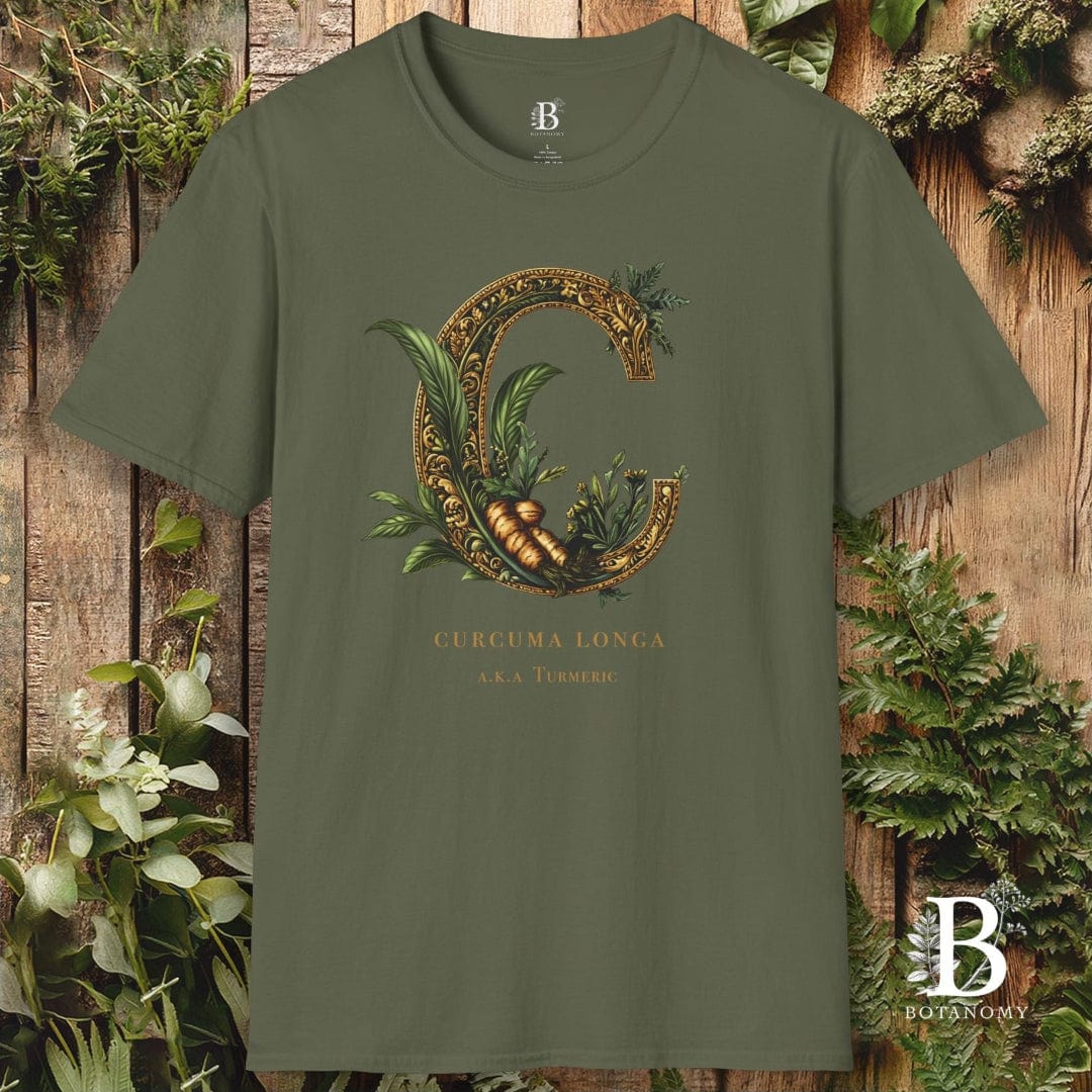 Green t-shirt with decorative letter 'C' design on a wooden background