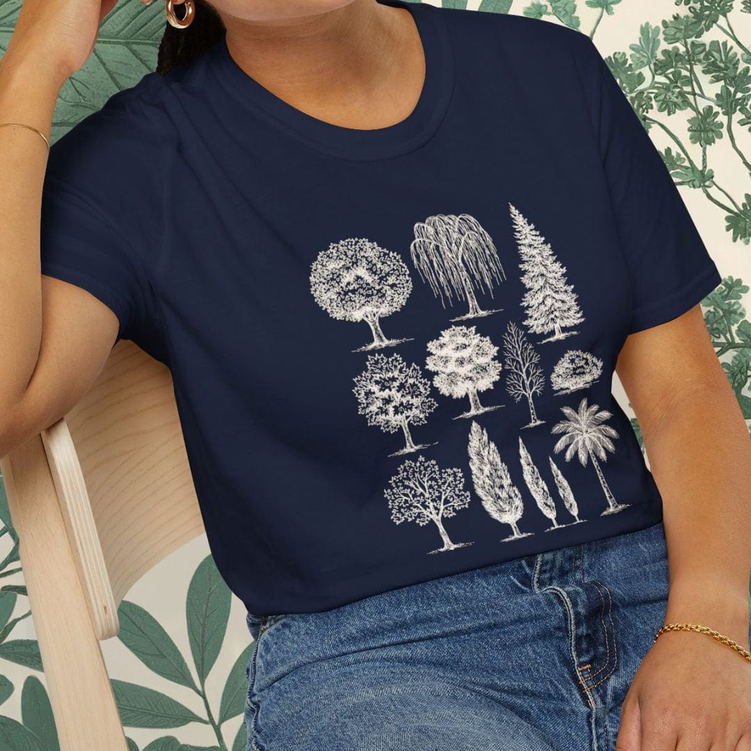 Woman wearing a navy blue t-shirt with tree graphics sitting on a chair.