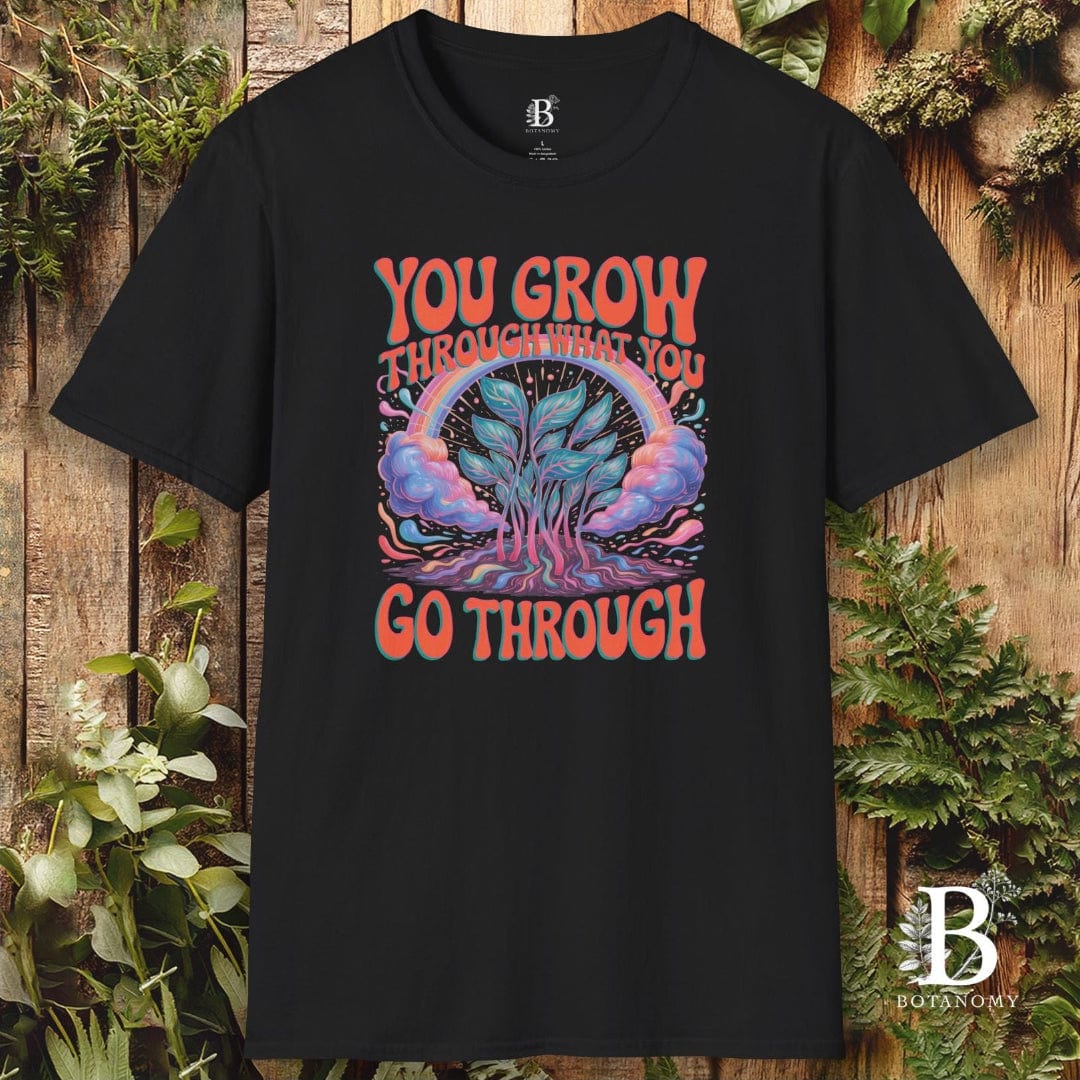 Black t-shirt with a colorful graphic and text on a wooden background