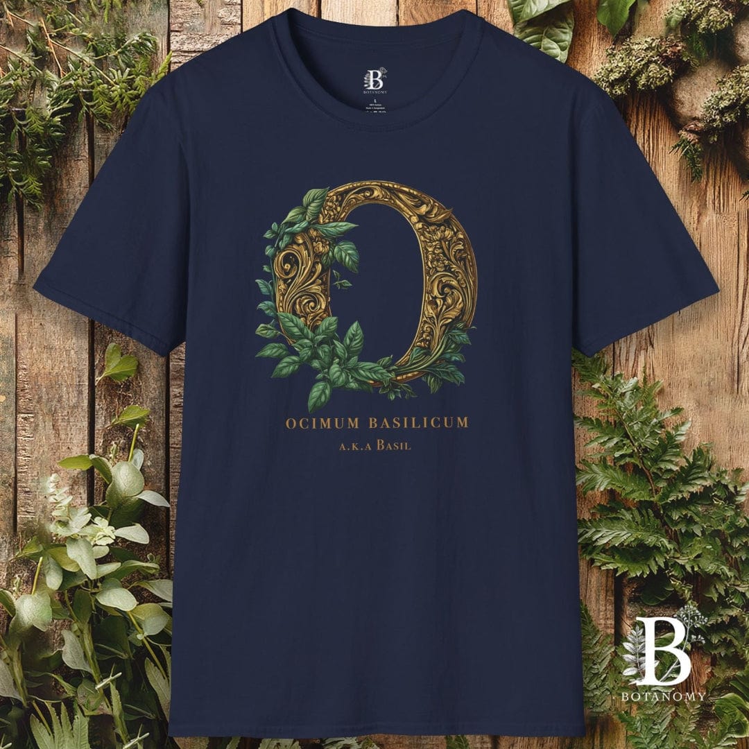 Navy blue t-shirt with decorative letter 'D' design on a wooden background with greenery