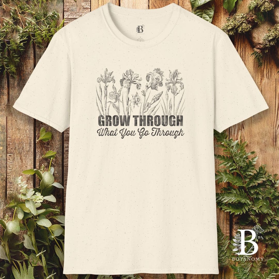 Beige t-shirt with floral design and text on a wooden background