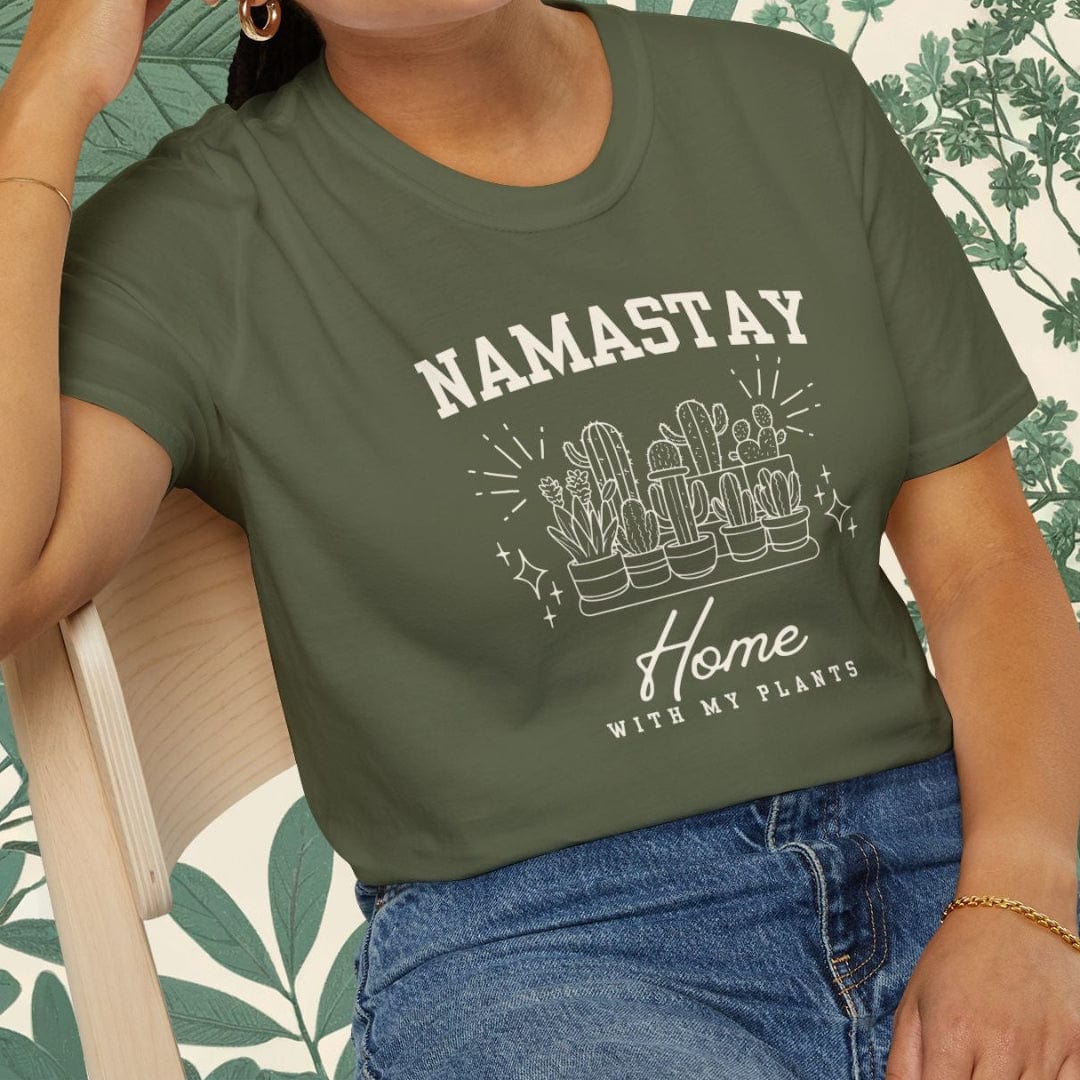 Woman wearing a green t-shirt with 'NAMASTAY HOME WITH MY PLANTS' text and cactus graphic.