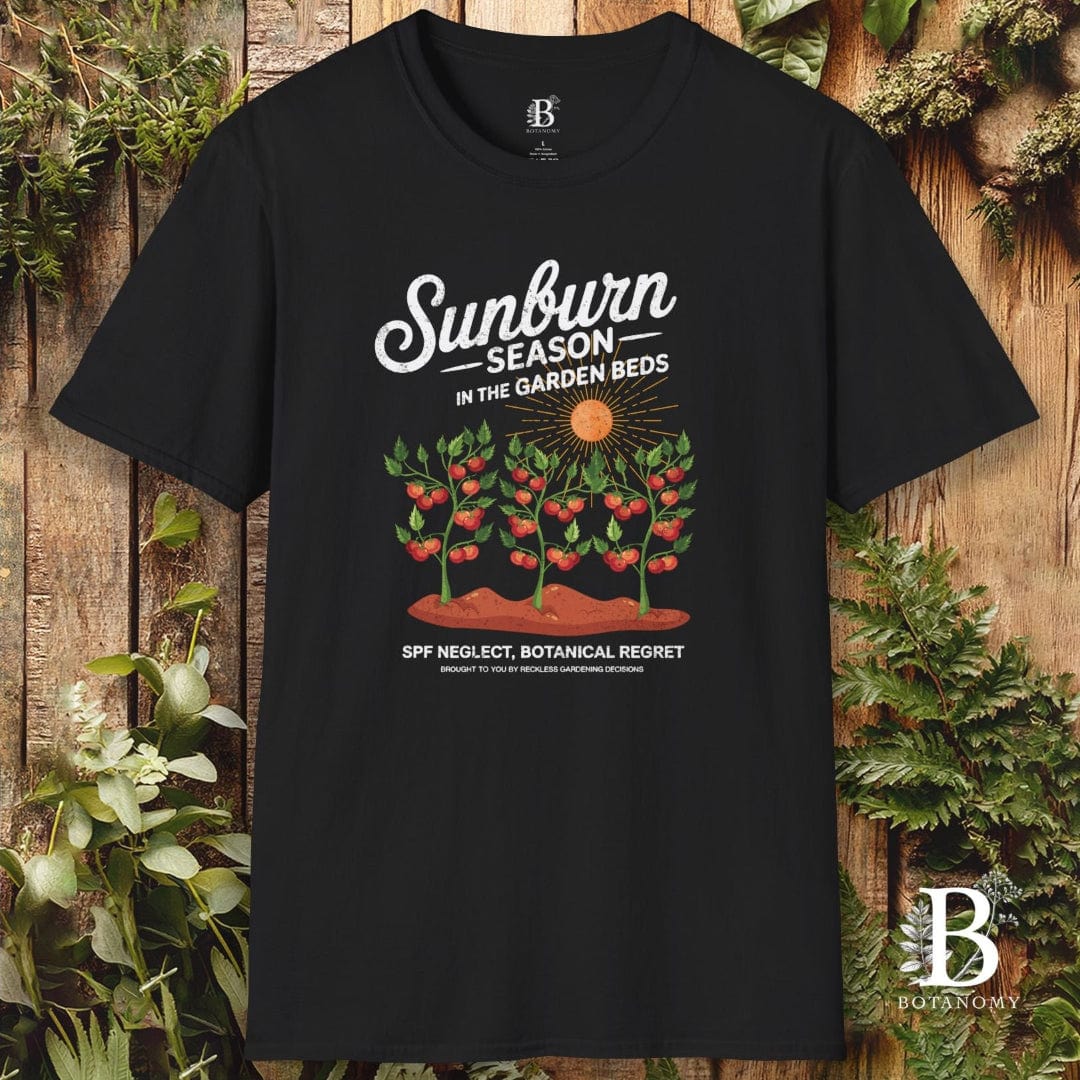 Black t-shirt with 'Sunburn Season' graphic design on a wooden background