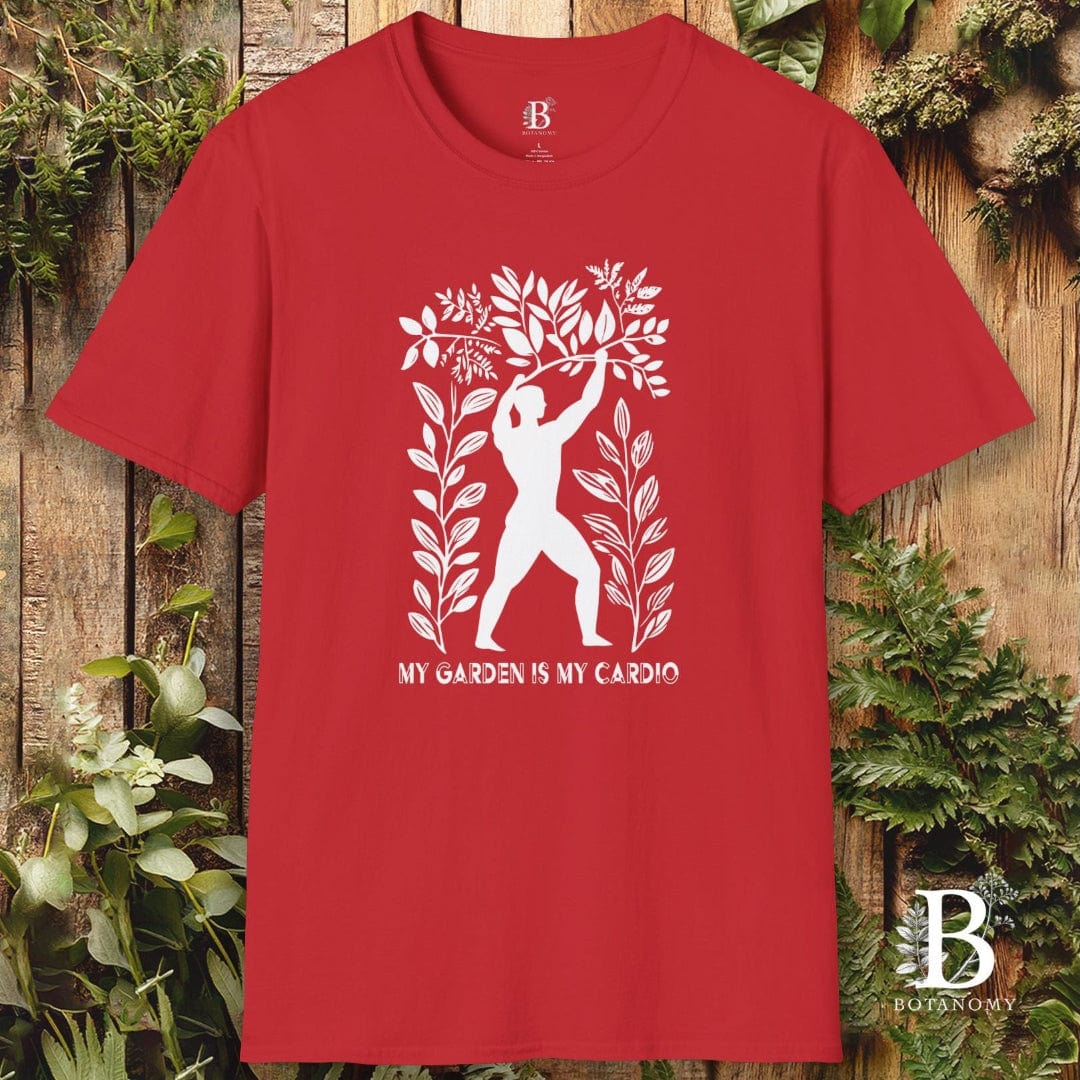 Red t-shirt with white graphic design and text on a wooden background with plants.