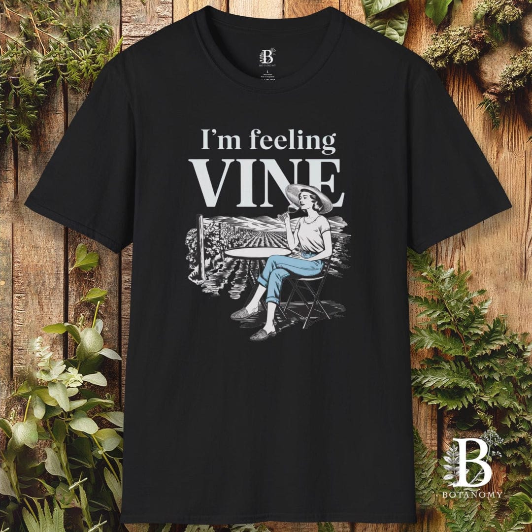 Black t-shirt with 'I'm feeling vine' graphic design on a wooden background