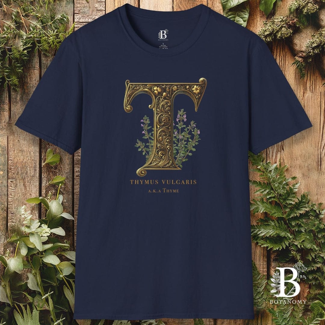 Navy blue t-shirt with gold letter 'T' design on a wooden background