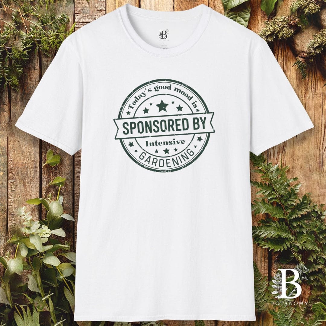 White t-shirt with a printed design on a wooden background with plants