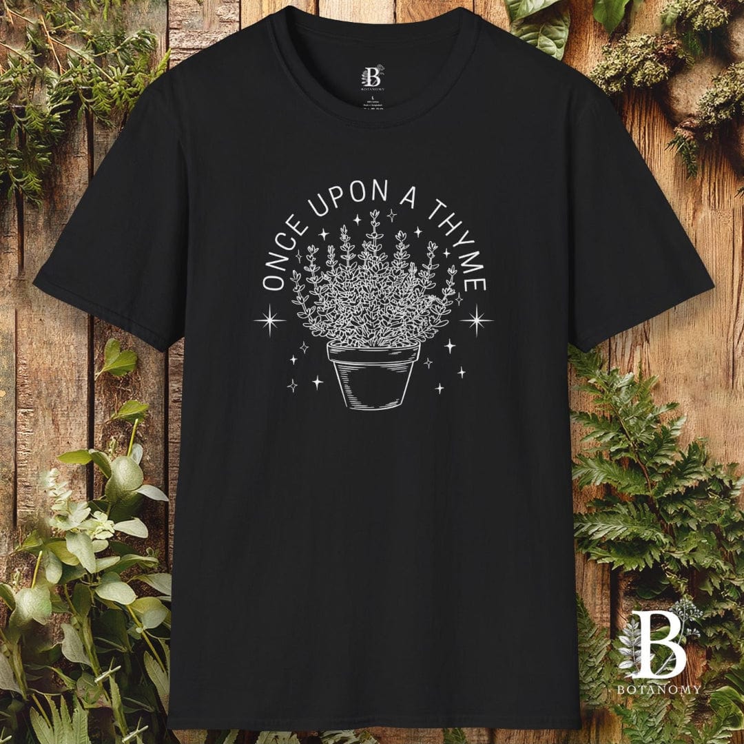 Black t-shirt with 'Once Upon a Thyme' design on a wooden background with plants