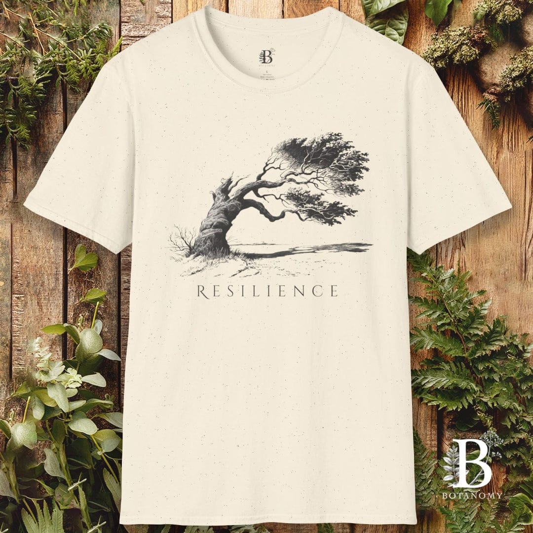 Beige t-shirt with tree graphic and 'Resilience' text on a wooden background