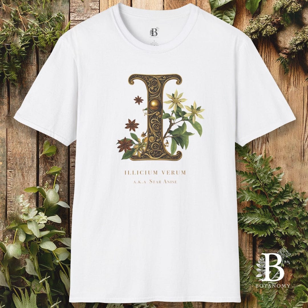 White t-shirt with decorative letter 'I' design on a wooden background with plants