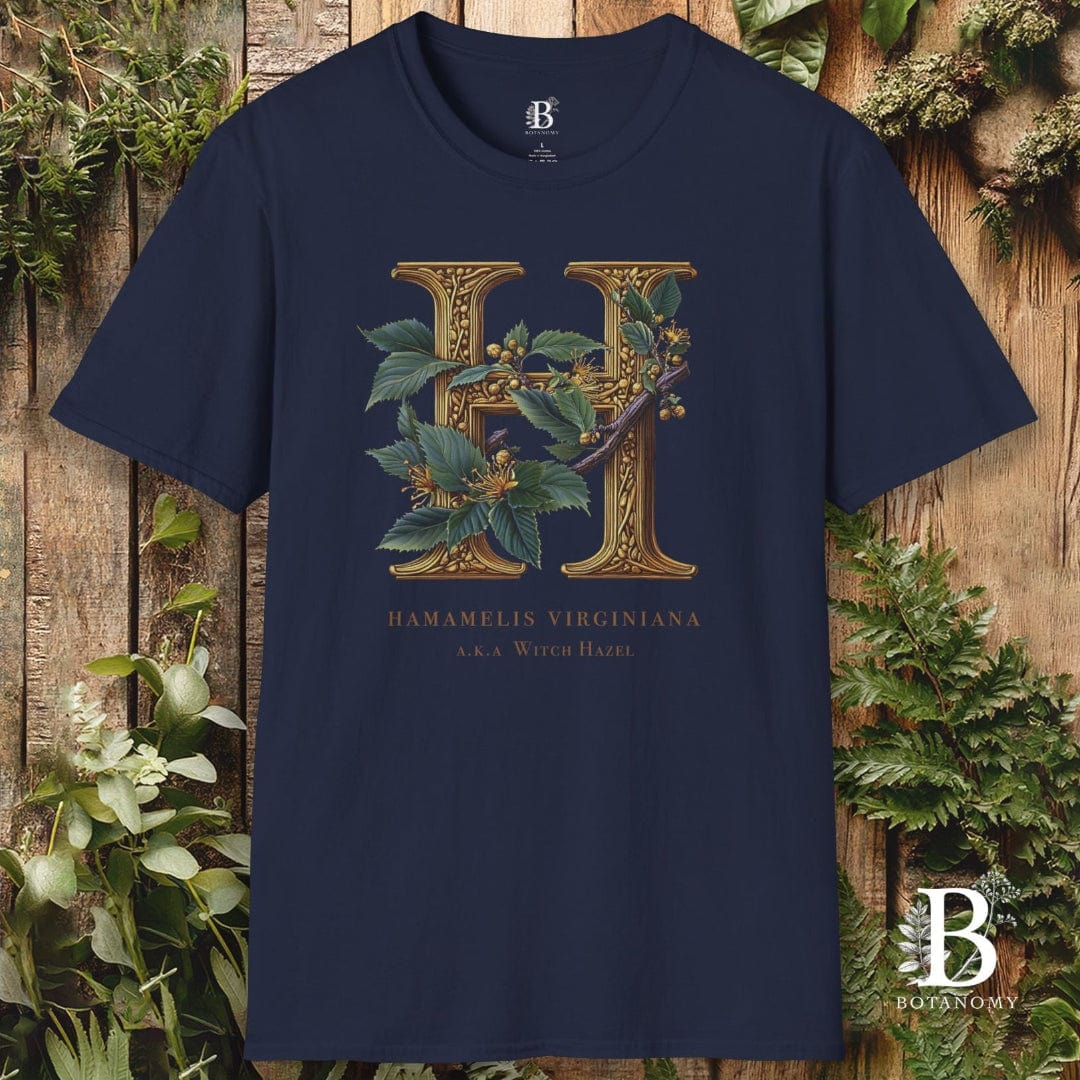 Navy blue t-shirt with floral letter 'H' design on a wooden background