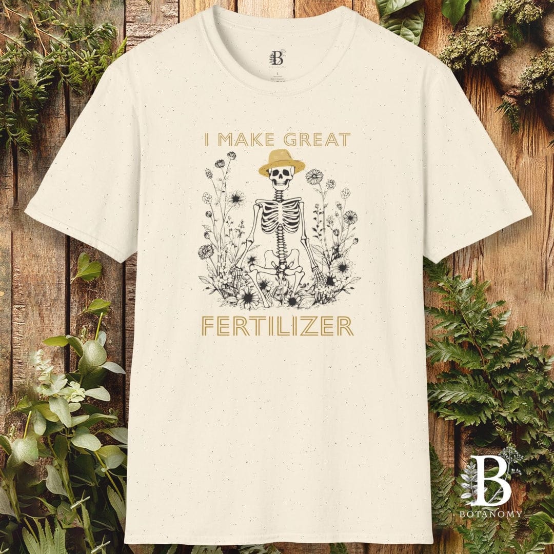 White t-shirt with skeleton design and text on a wooden background with plants