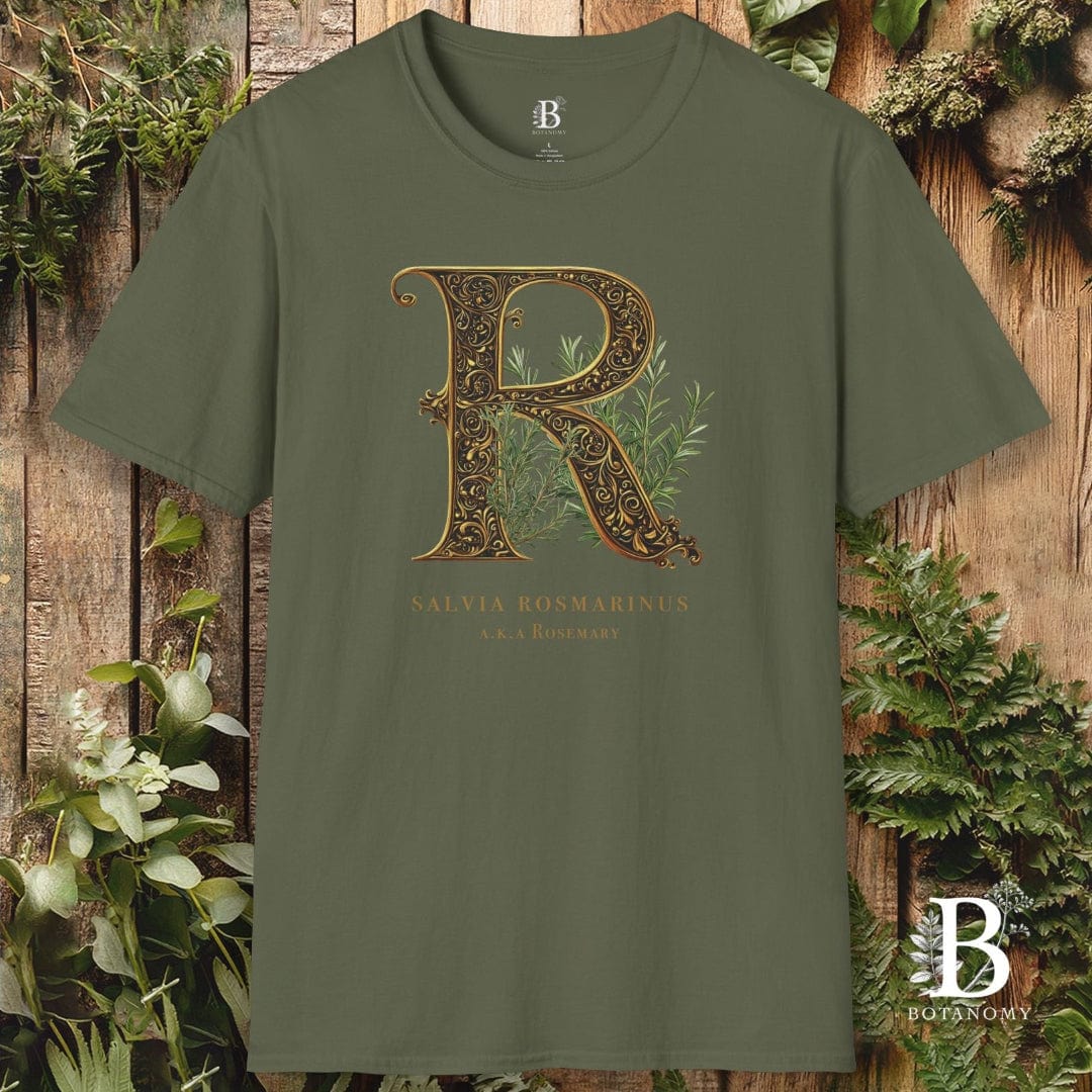 Green t-shirt with decorative letter 'R' design on a wooden background with plants