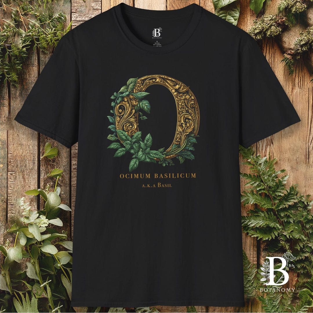 Black t-shirt with decorative letter 'O' design on a wooden background with plants