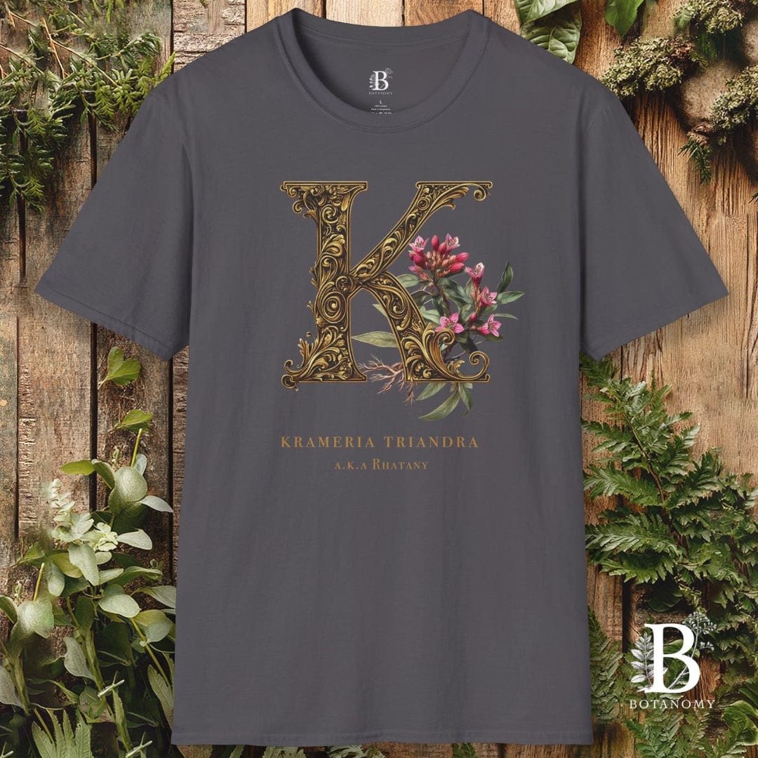 Gray t-shirt with decorative letter 'K' design on a wooden background