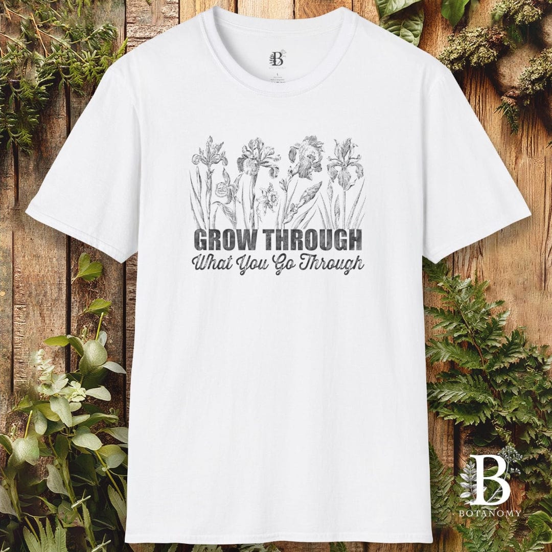 White t-shirt with floral design and text on a wooden background
